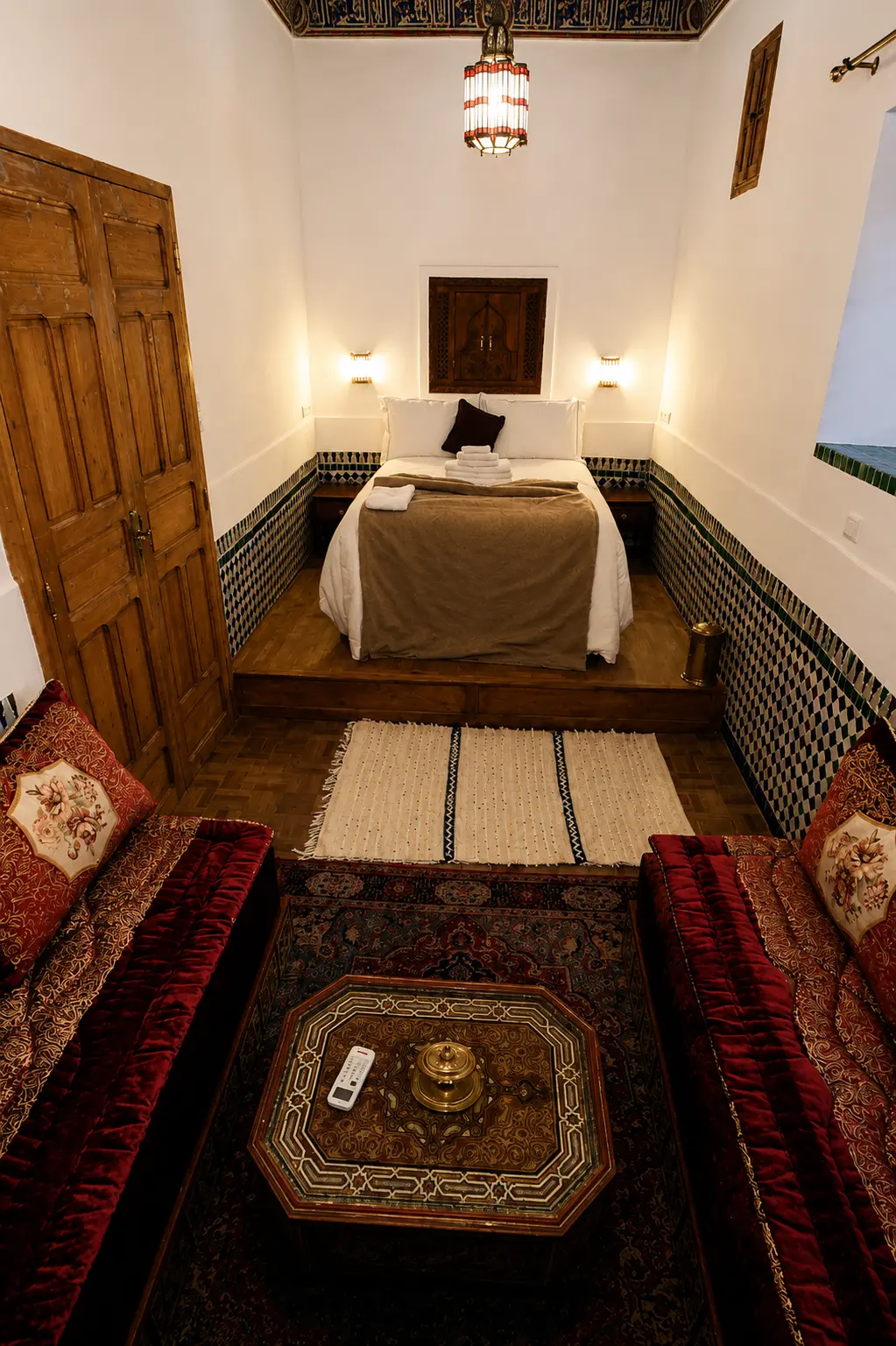 The room under its painted wooden ceiling, with a low banquette